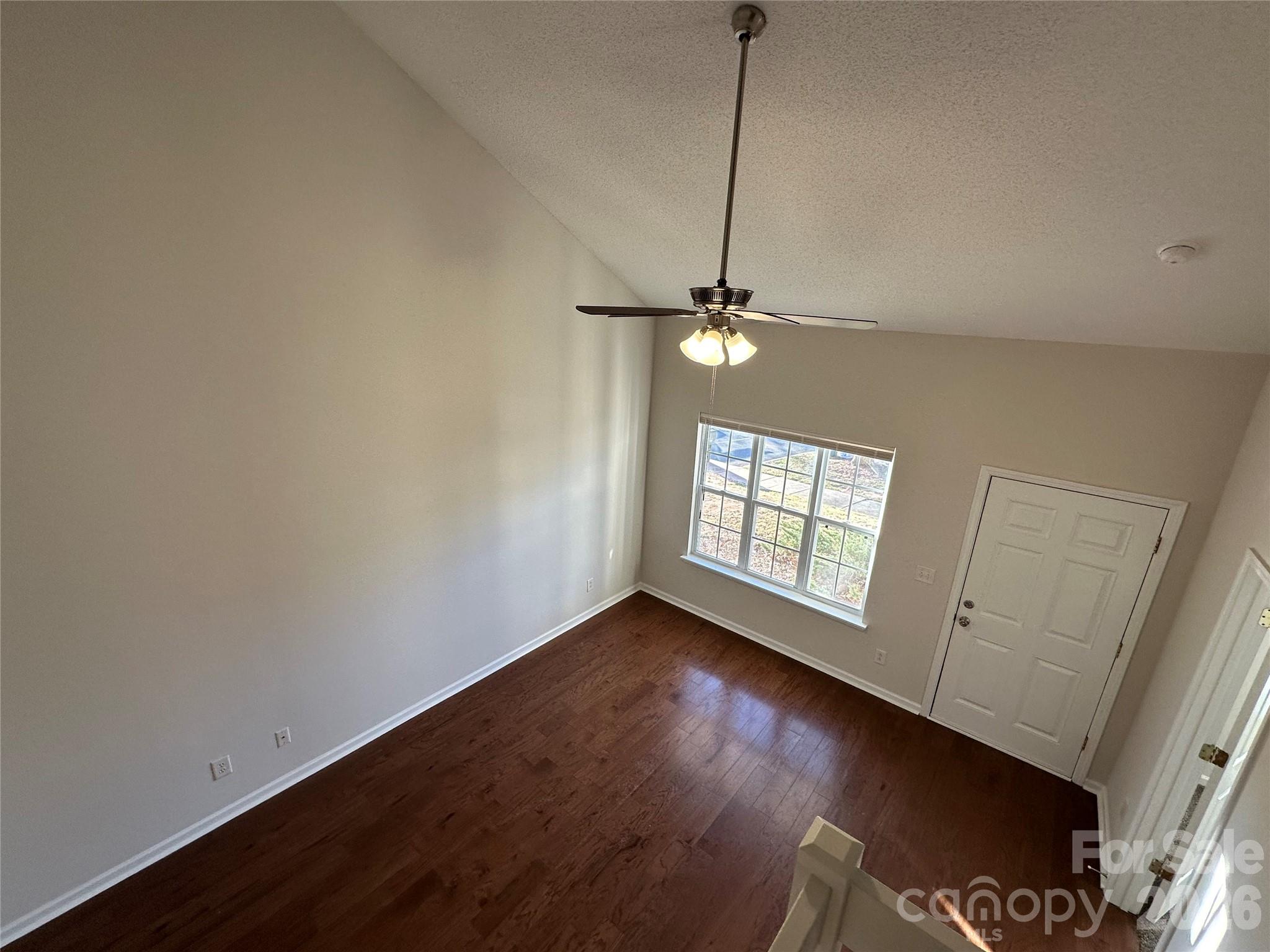 5227 Magnolia Tree Lane Charlotte, NC 28215 - Photo 7 of 20 a view of an empty room with window and hardwood floor