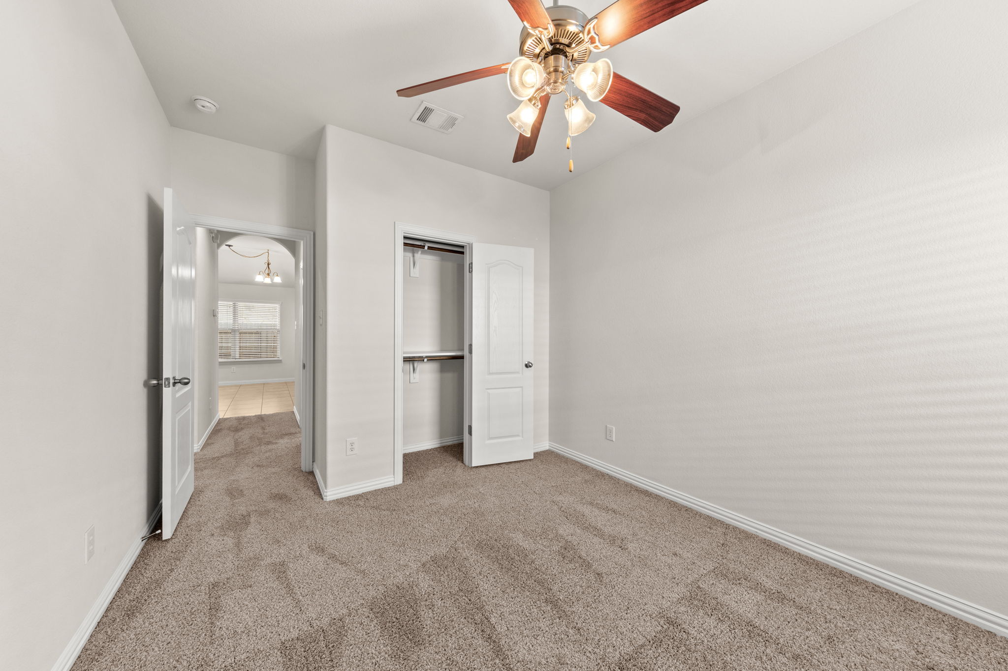 411 Tascate Street Georgetown, TX 78628 - Photo 29 of 41 A versatile room featuring neutral carpeting and a ceiling fan, offering comfortable living.