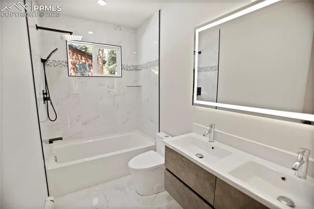 a bathroom with a tub sink toilet and a mirror