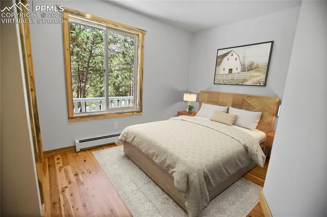 a large bed sitting in a bedroom next to a window