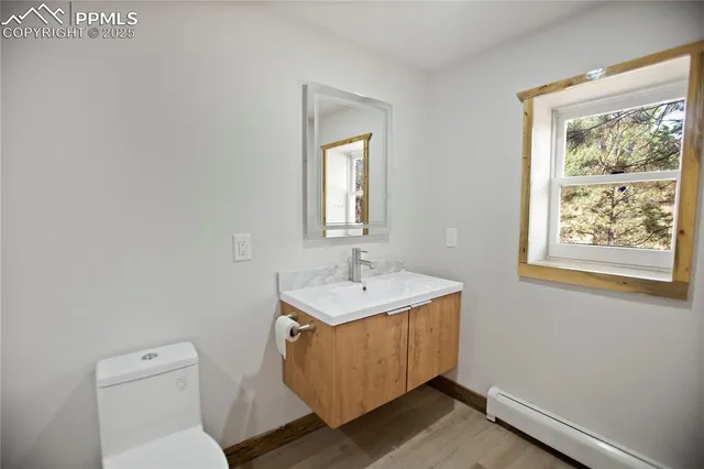 a bathroom with a toilet a sink and mirror