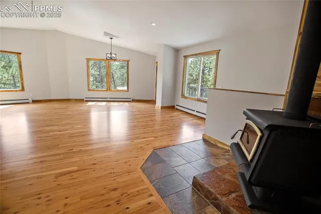 a large kitchen with cabinets wooden floor and a sink