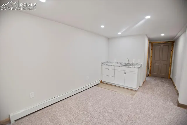 an empty room with windows and closet