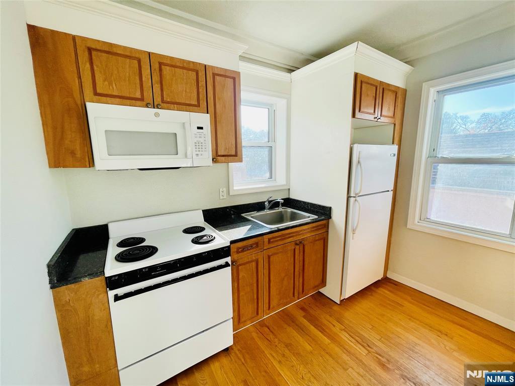 229 Orient Way, Unit 6 Rutherford, NJ 07070 - Photo 2 of 8 a kitchen with stainless steel appliances a stove a sink and a refrigerator