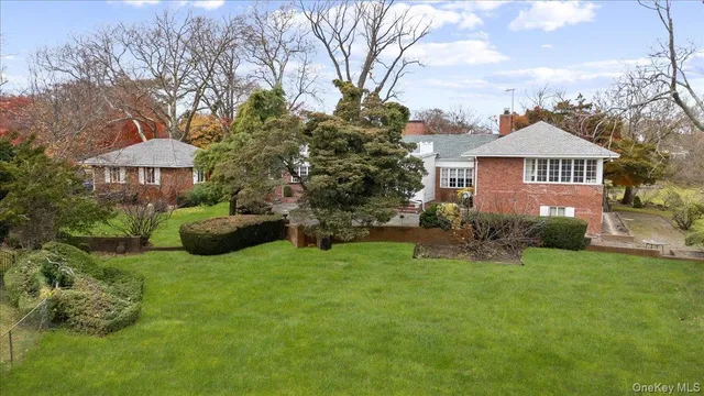 a view of a house with a yard and sitting area