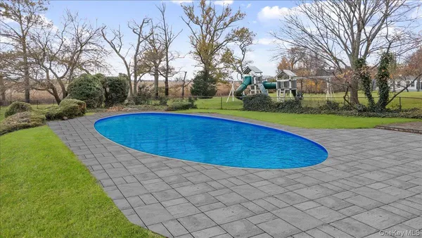a view of a swimming pool and trees in the background