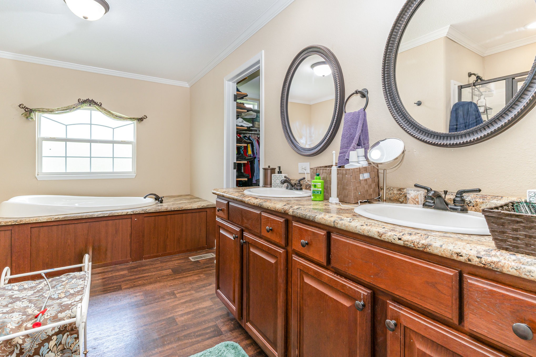 4075 Woodard Road Springfield, TN 37172 - Photo 15 of 30 a bathroom with a granite countertop bathtub a double vanity sink and a mirror