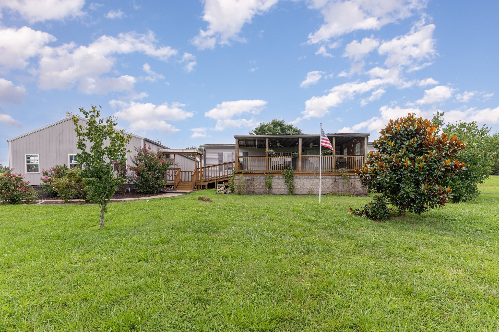 4075 Woodard Road Springfield, TN 37172 - Photo 2 of 30 a backyard of a house with plants and large trees