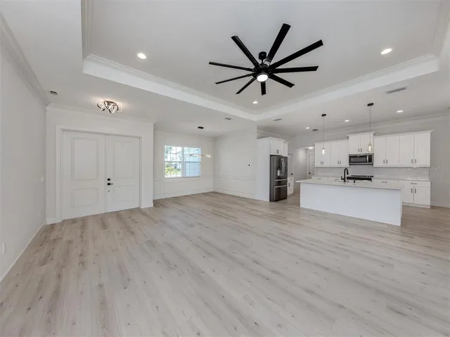 a view of empty room with wooden floor and window