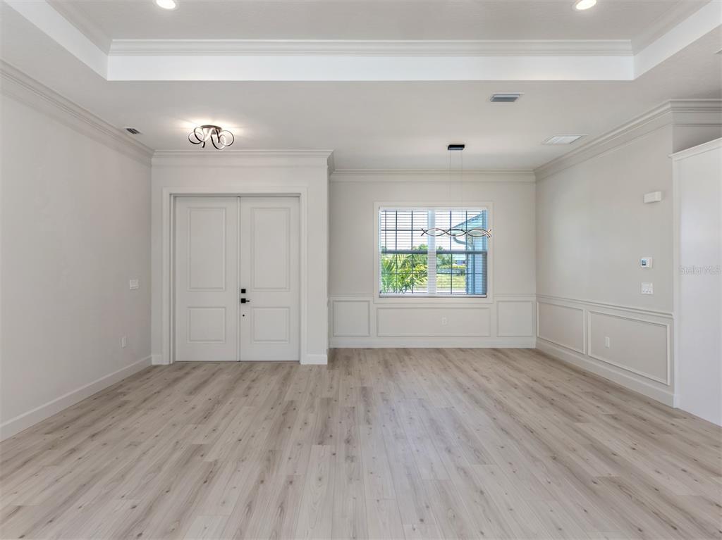 65 Fairway Road Rotonda West, FL 33947 - Photo 12 of 40 wooden floor in an empty room with a window