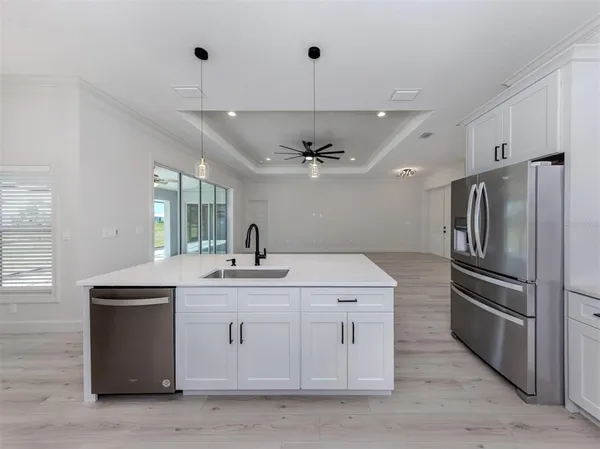 a kitchen with a sink stainless steel appliances and cabinets