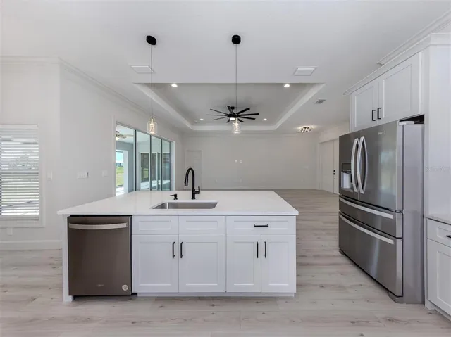 a kitchen with a sink stainless steel appliances and cabinets