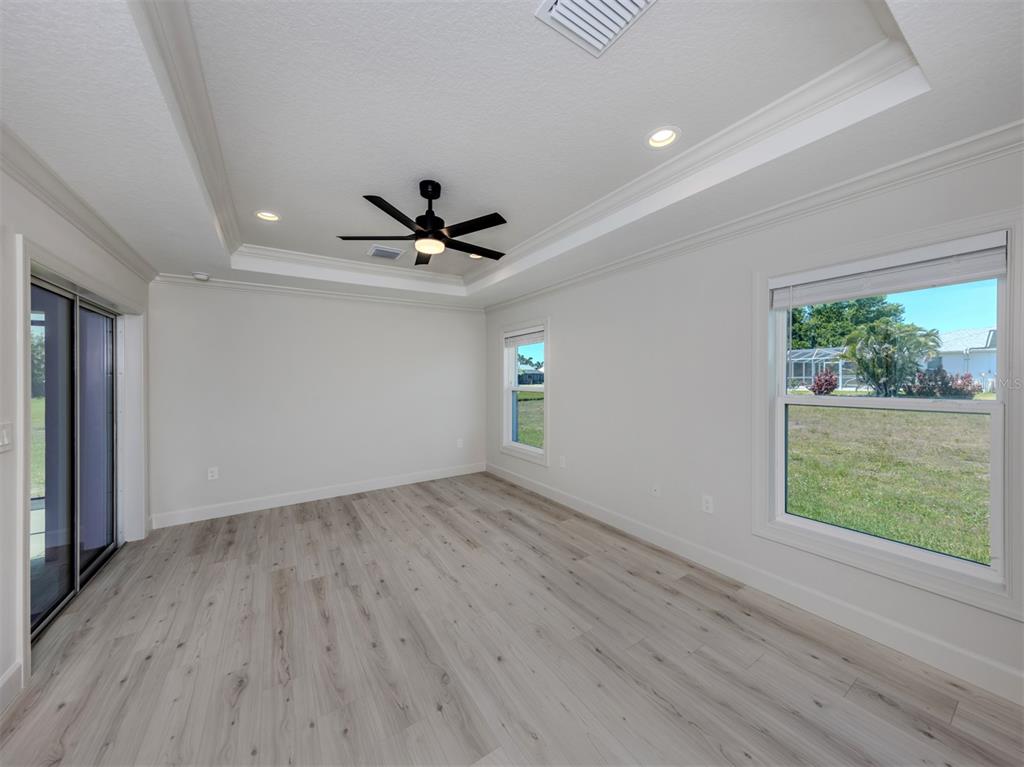 65 Fairway Road Rotonda West, FL 33947 - Photo 21 of 40 a view of empty room with wooden floor and fan