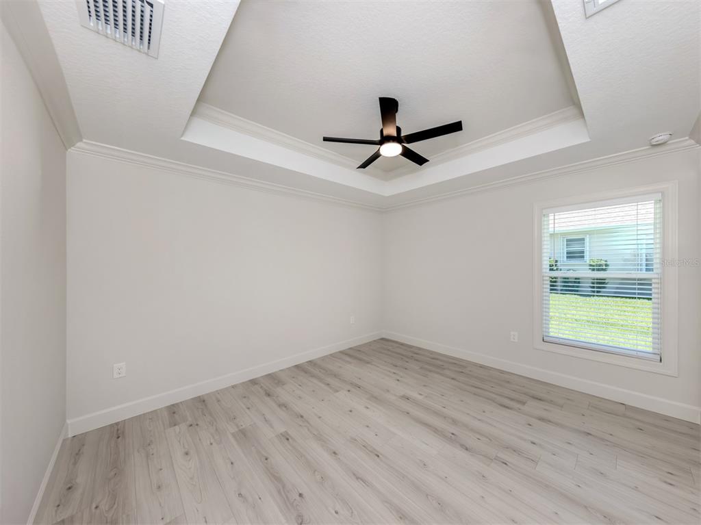 65 Fairway Road Rotonda West, FL 33947 - Photo 28 of 40 an empty room with a window and a ceiling fan