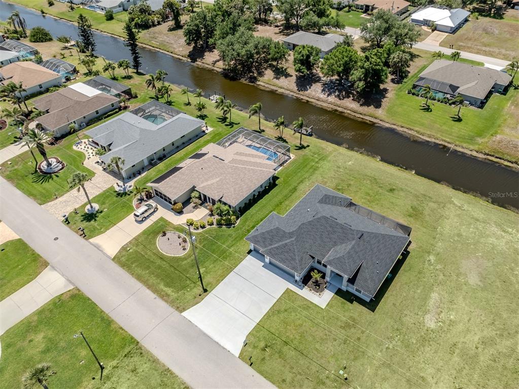 65 Fairway Road Rotonda West, FL 33947 - Photo 33 of 40 an aerial view of a house with a garden and swimming pool