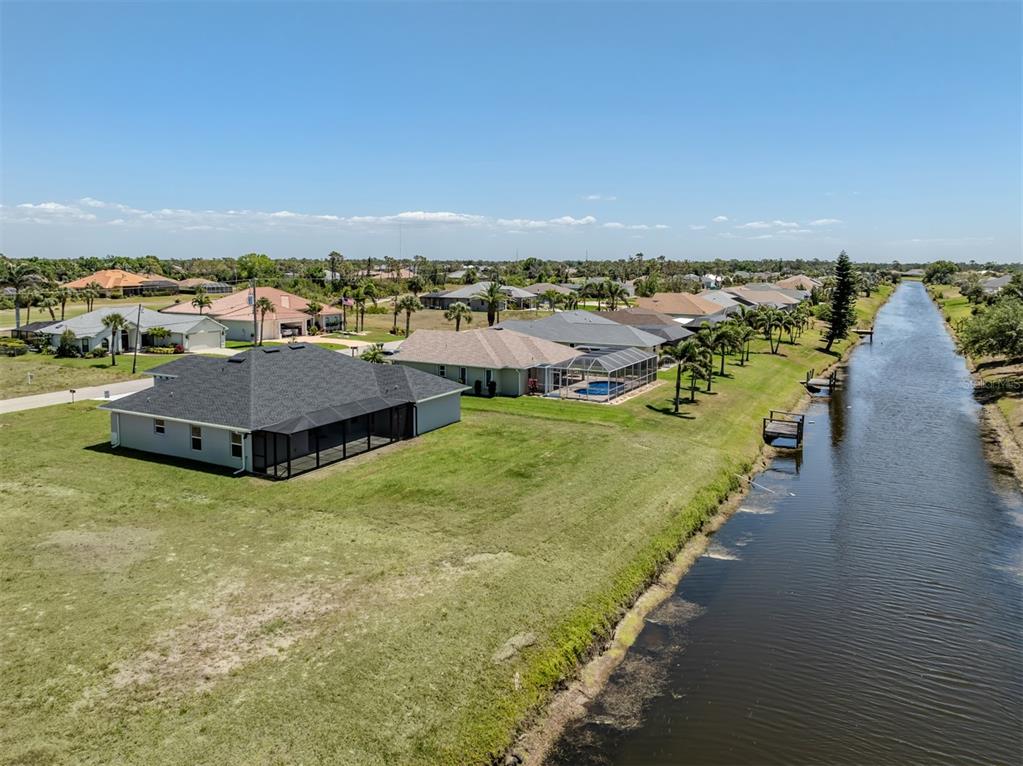 65 Fairway Road Rotonda West, FL 33947 - Photo 35 of 40 an aerial view of a house with a garden and lake view