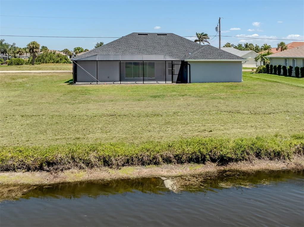 65 Fairway Road Rotonda West, FL 33947 - Photo 36 of 40 a front view of a house with a yard