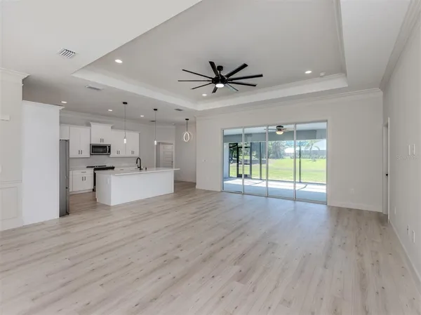 a view of an empty room with a kitchen