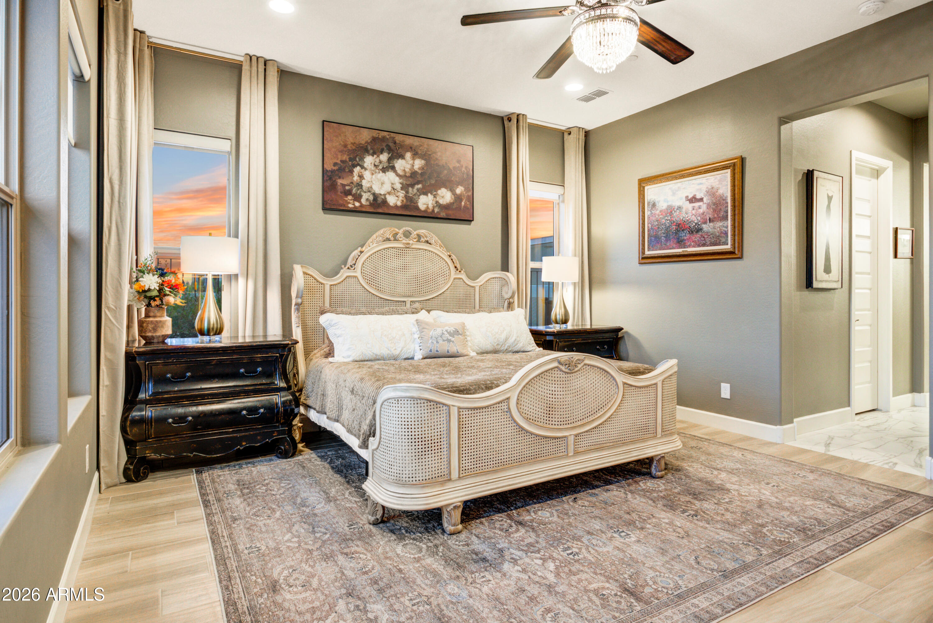 28517 North Camel Rock Court Rio Verde, AZ 85263 - Photo 16 of 39 a bedroom with a bed and a chandelier