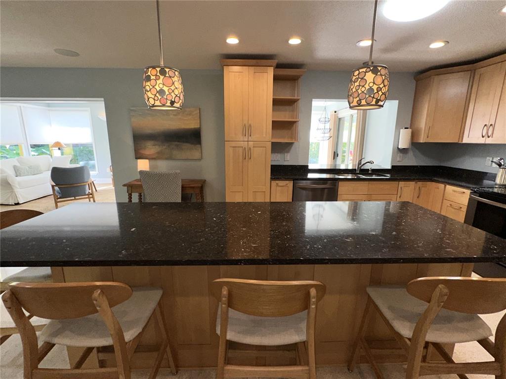 1883 Riviera Circle Sarasota, FL 34232 - Photo 13 of 45 a view of a dining room with furniture a chandelier and kitchen view
