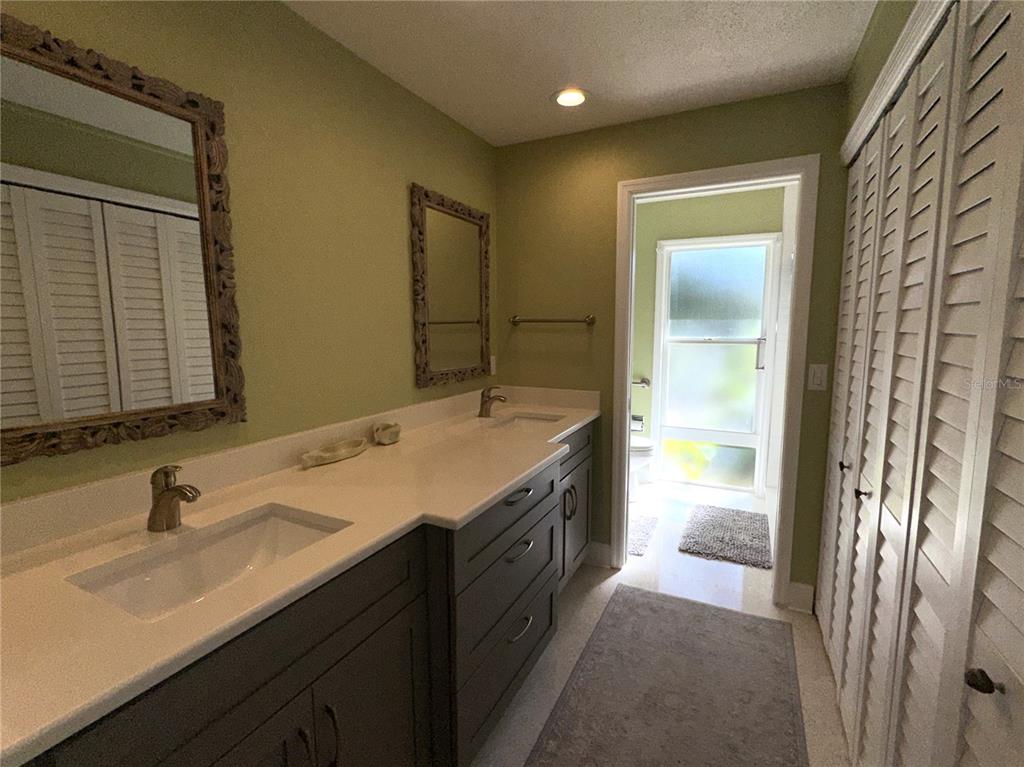 1883 Riviera Circle Sarasota, FL 34232 - Photo 18 of 45 a bathroom with a double vanity sink and a mirror