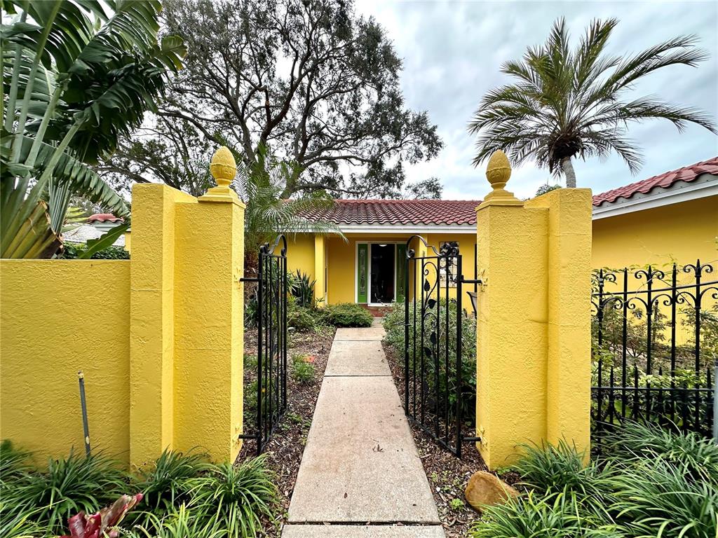 1883 Riviera Circle Sarasota, FL 34232 - Photo 2 of 45 a front view of a house with a garden