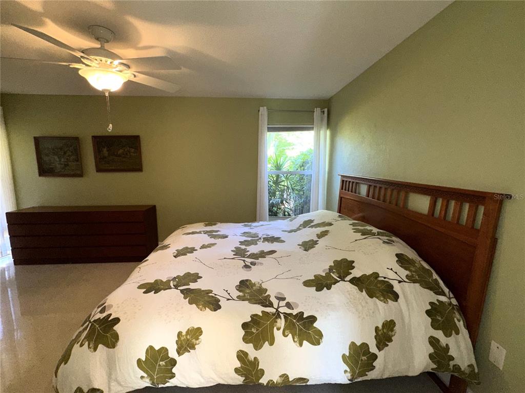 1883 Riviera Circle Sarasota, FL 34232 - Photo 21 of 45 a bedroom with a bed and a chandelier