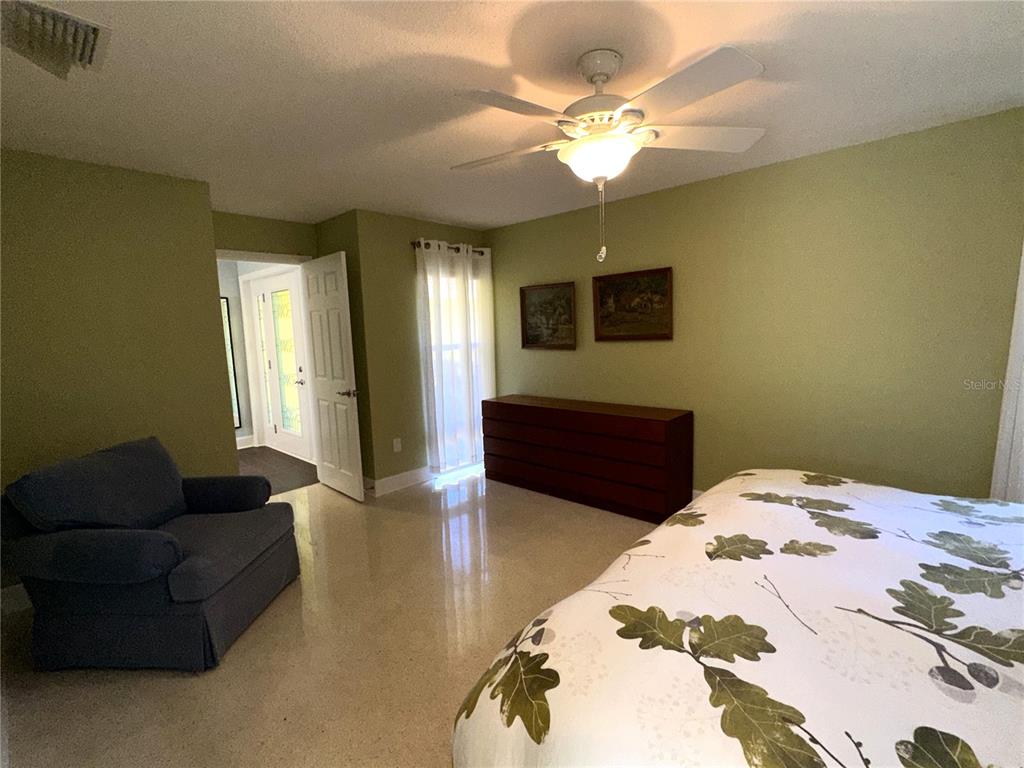 1883 Riviera Circle Sarasota, FL 34232 - Photo 22 of 45 a bedroom with a bed couch and window
