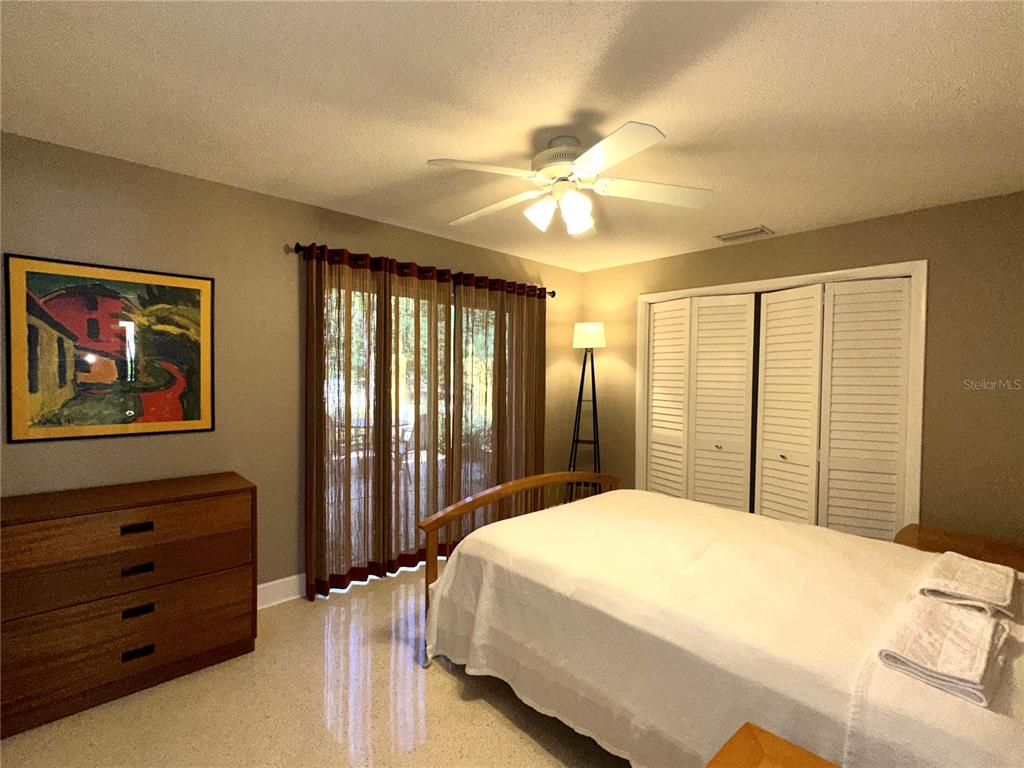 1883 Riviera Circle Sarasota, FL 34232 - Photo 24 of 45 a bedroom with a large bed and a chandelier