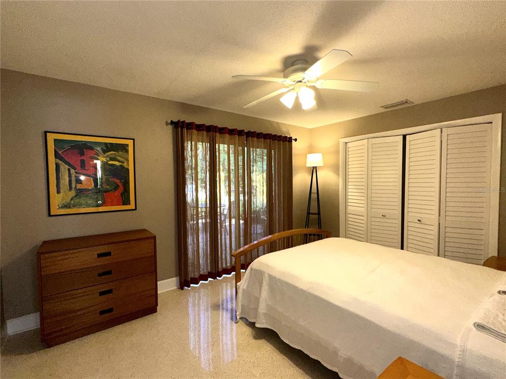 1883 Riviera Circle Sarasota, FL 34232 - Photo 25 of 45 a bedroom with a bed and a chandelier
