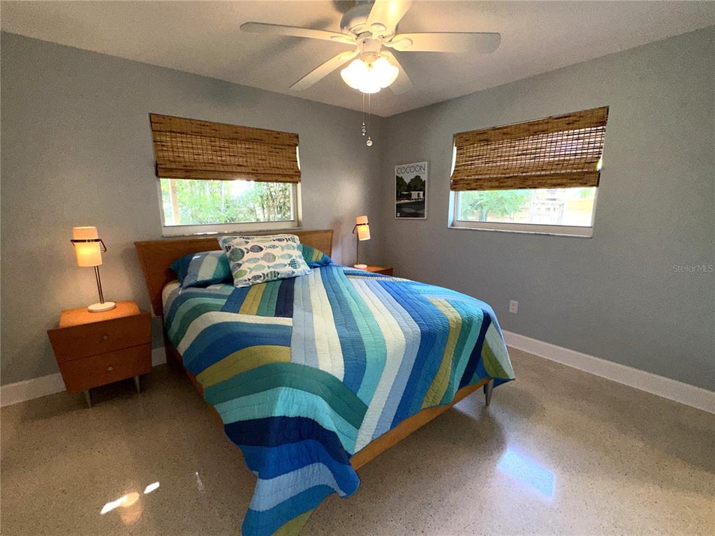 1883 Riviera Circle Sarasota, FL 34232 - Photo 27 of 45 a bedroom with a bed and a chandelier