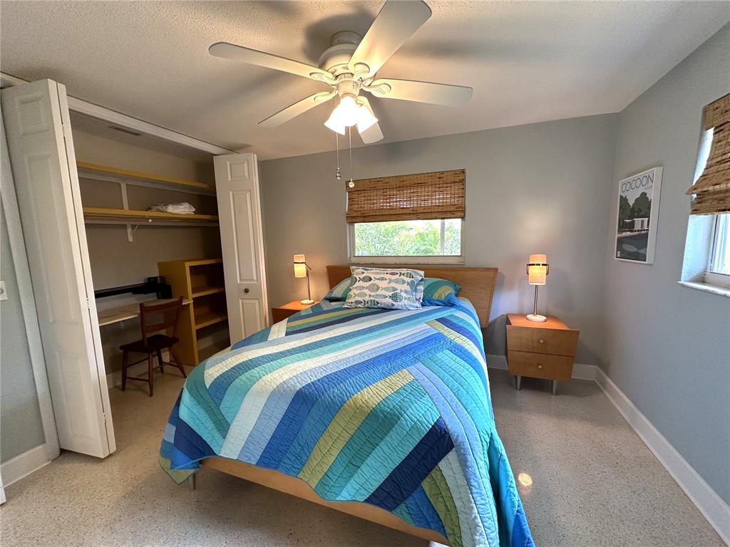 1883 Riviera Circle Sarasota, FL 34232 - Photo 29 of 45 a bedroom with a bed and a chandelier