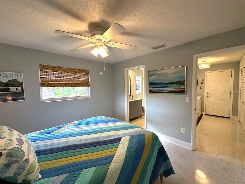 1883 Riviera Circle Sarasota, FL 34232 - Photo 30 of 45 a bedroom with a bed and a chandelier