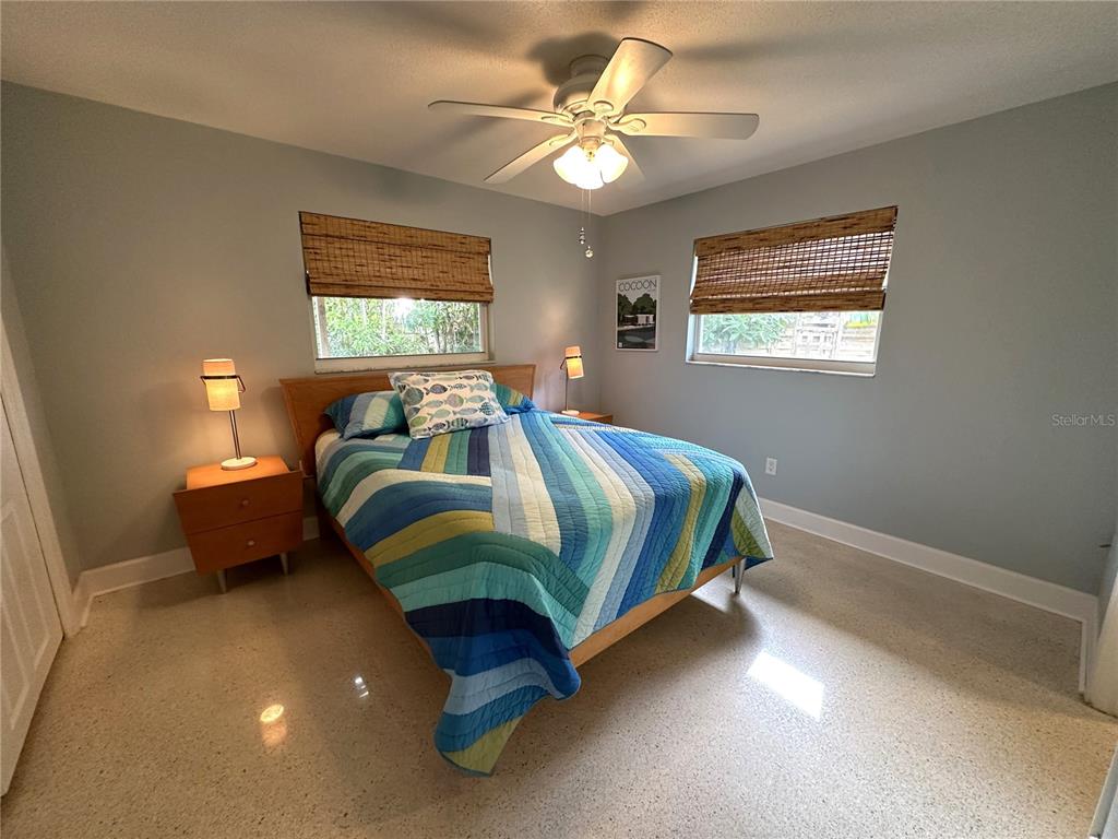 1883 Riviera Circle Sarasota, FL 34232 - Photo 32 of 45 a bedroom with a bed and a chandelier