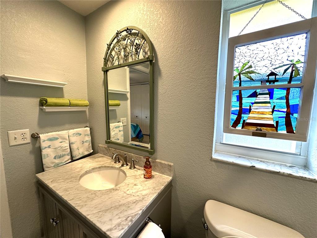 1883 Riviera Circle Sarasota, FL 34232 - Photo 34 of 45 a bathroom with a granite countertop sink and a mirror
