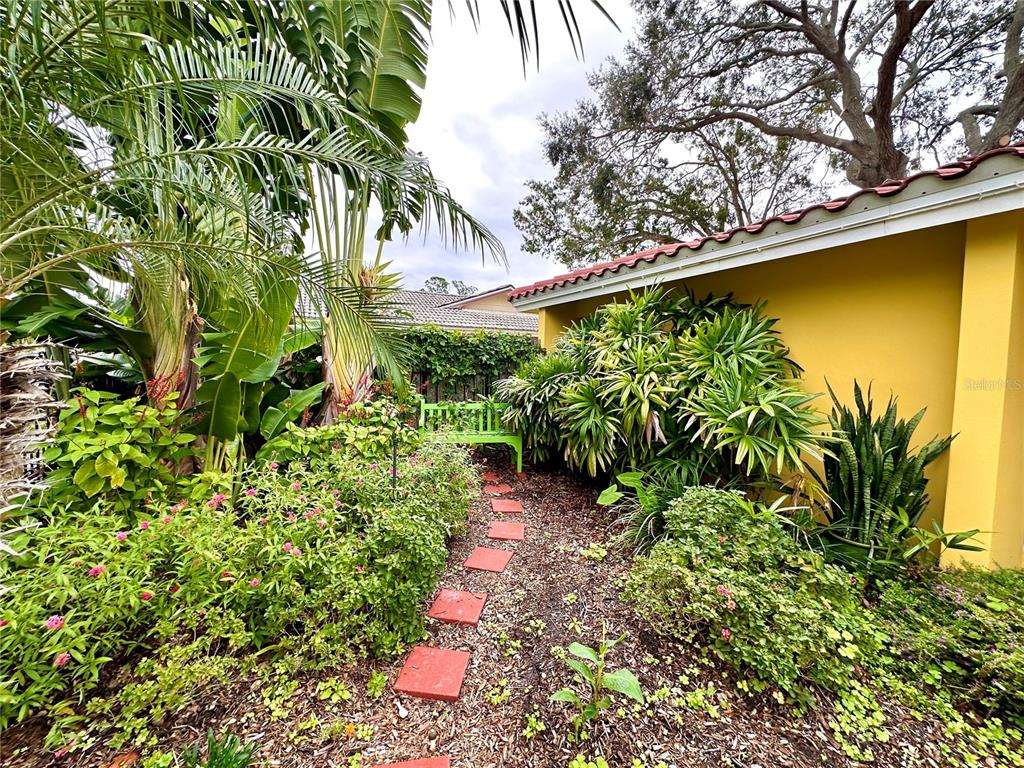 1883 Riviera Circle Sarasota, FL 34232 - Photo 38 of 45 a backyard of a house with lots of green space and fountain