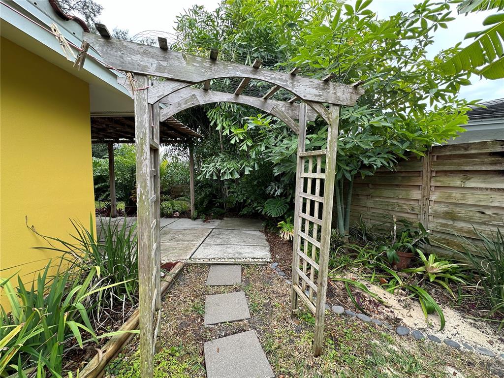 1883 Riviera Circle Sarasota, FL 34232 - Photo 5 of 45 a view of a patio with table and chairs with wooden floor and plants