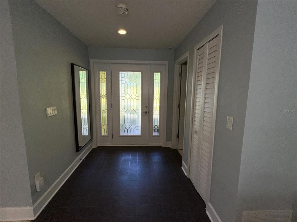 1883 Riviera Circle Sarasota, FL 34232 - Photo 8 of 45 an empty room with wooden floor and windows