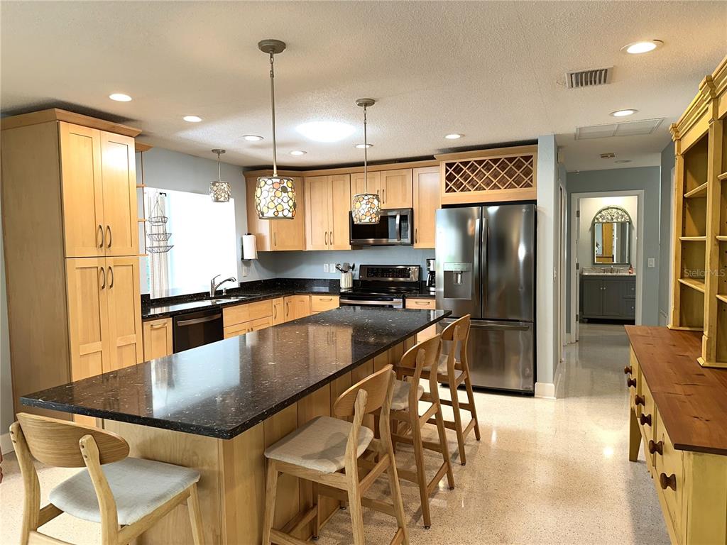 1883 Riviera Circle Sarasota, FL 34232 - Photo 10 of 45 a kitchen with stainless steel appliances granite countertop a refrigerator a sink a stove and cabinets