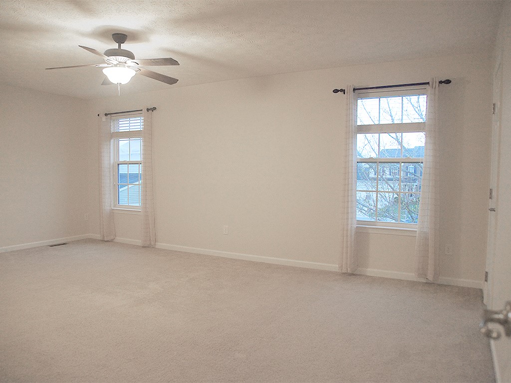1978 Spring Ridge Drive Xenia, OH 45385 - Photo 20 of 44 This spacious bedroom offers abundant natural light and comfortable carpeting, perfect for peaceful living.