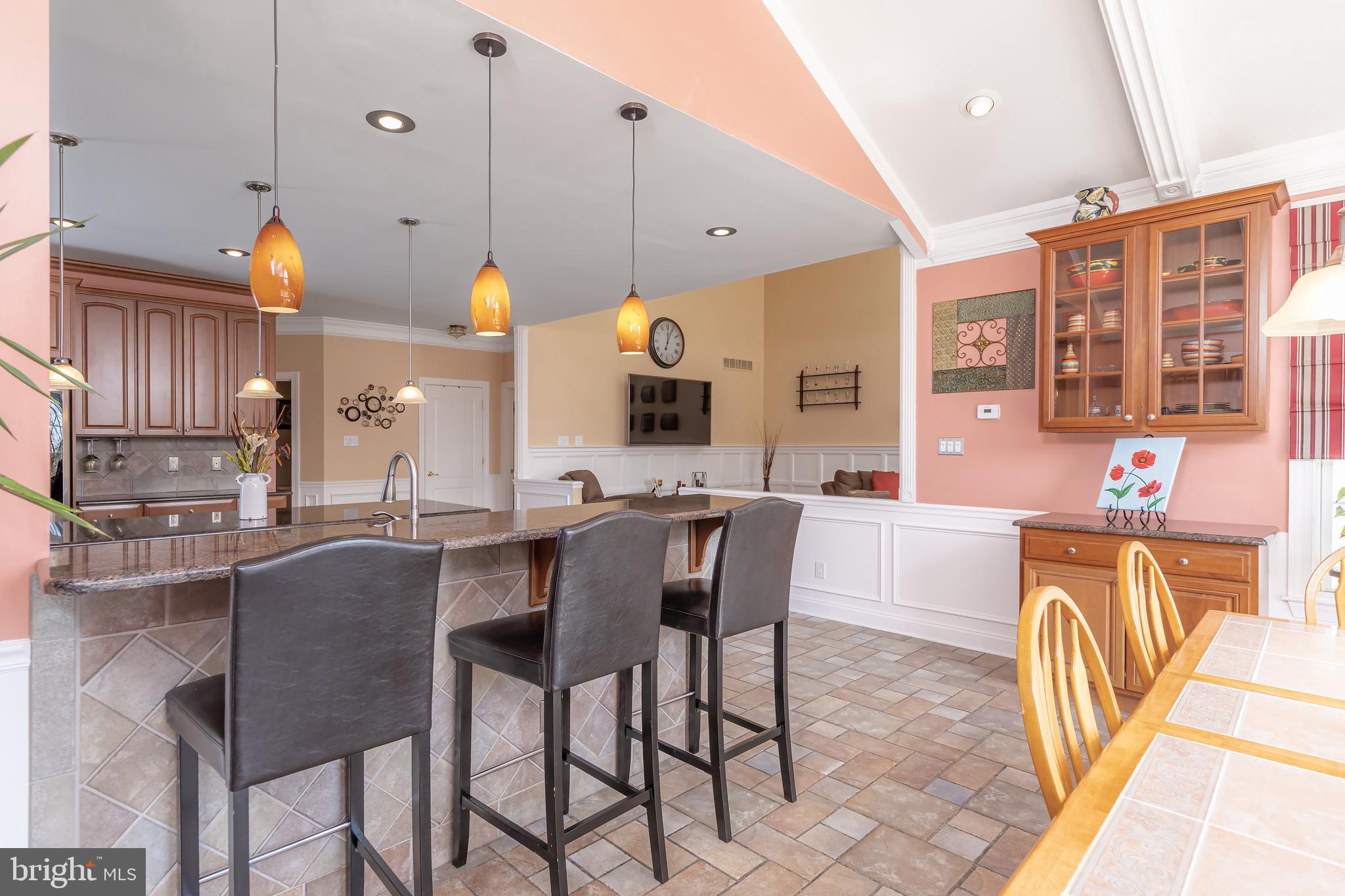 612 Bainbridge Drive Mullica Hill, NJ 08062 - Photo 13 of 42 a kitchen with stainless steel appliances a table and chairs