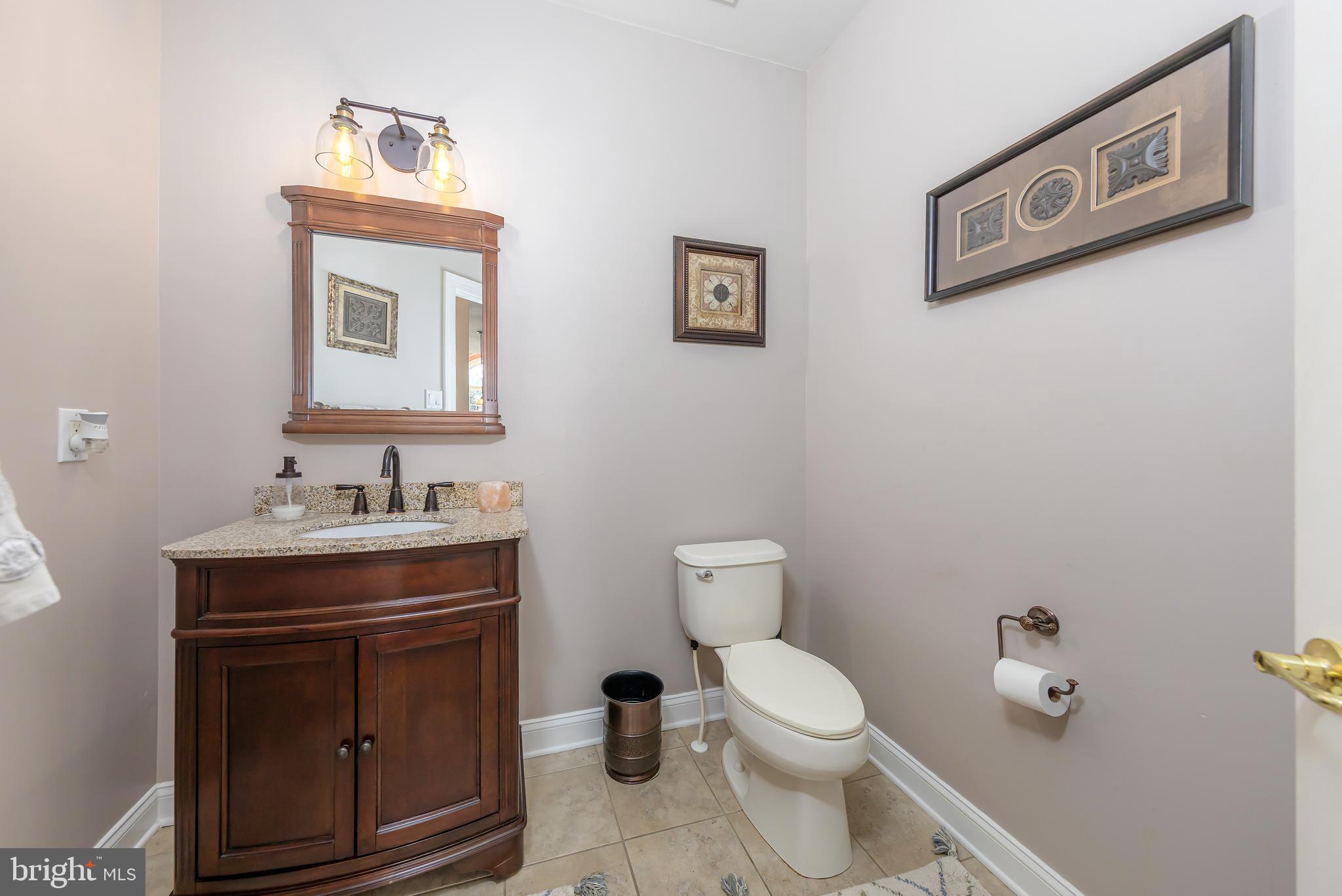 612 Bainbridge Drive Mullica Hill, NJ 08062 - Photo 18 of 42 a bathroom with a toilet a sink and mirror