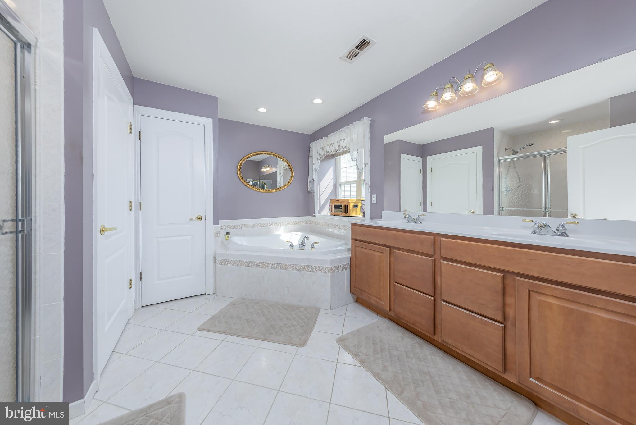 612 Bainbridge Drive Mullica Hill, NJ 08062 - Photo 23 of 42 a bathroom with a sink a toilet and mirror