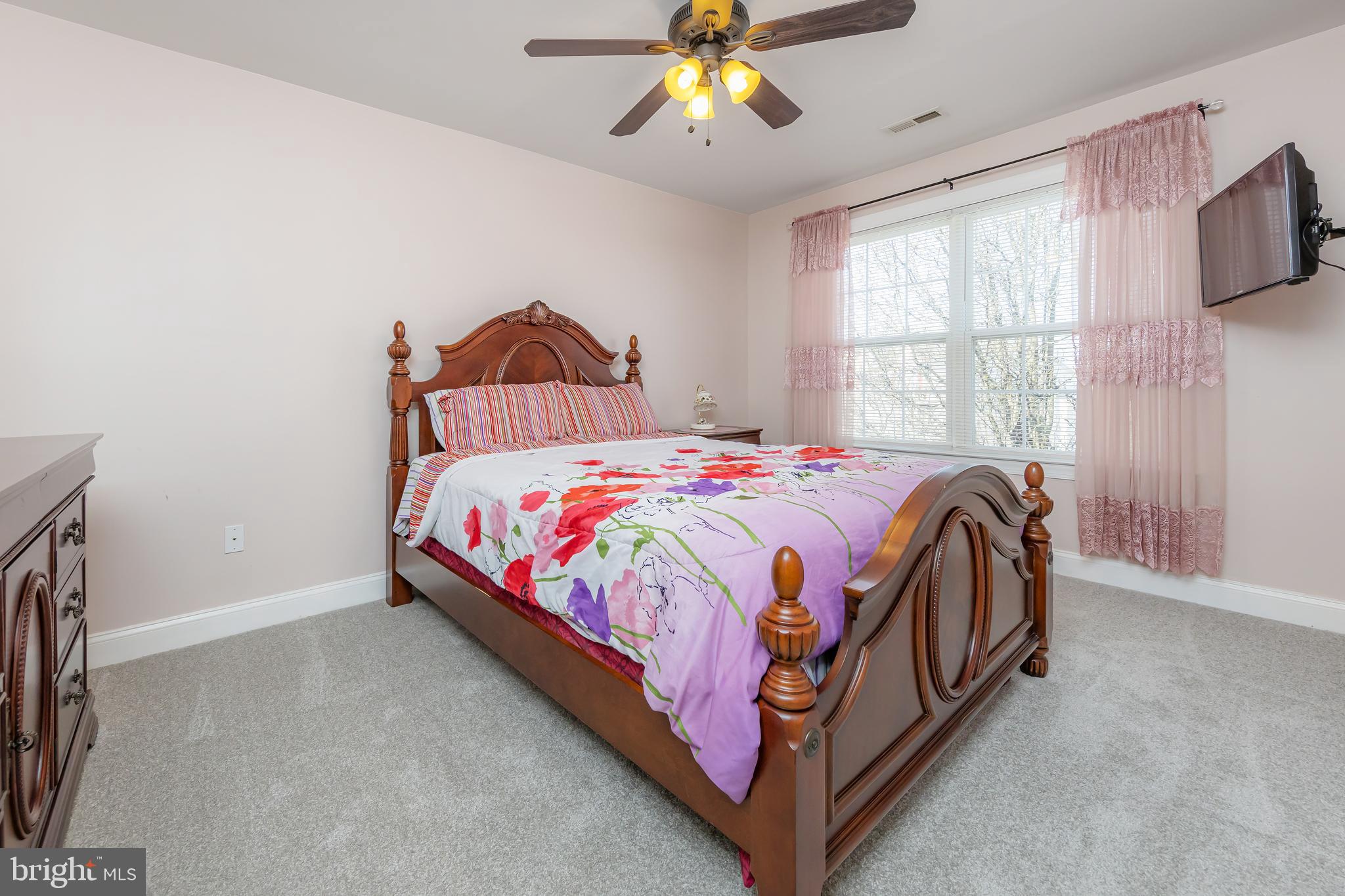 612 Bainbridge Drive Mullica Hill, NJ 08062 - Photo 24 of 42 a bedroom with a bed and a chandelier