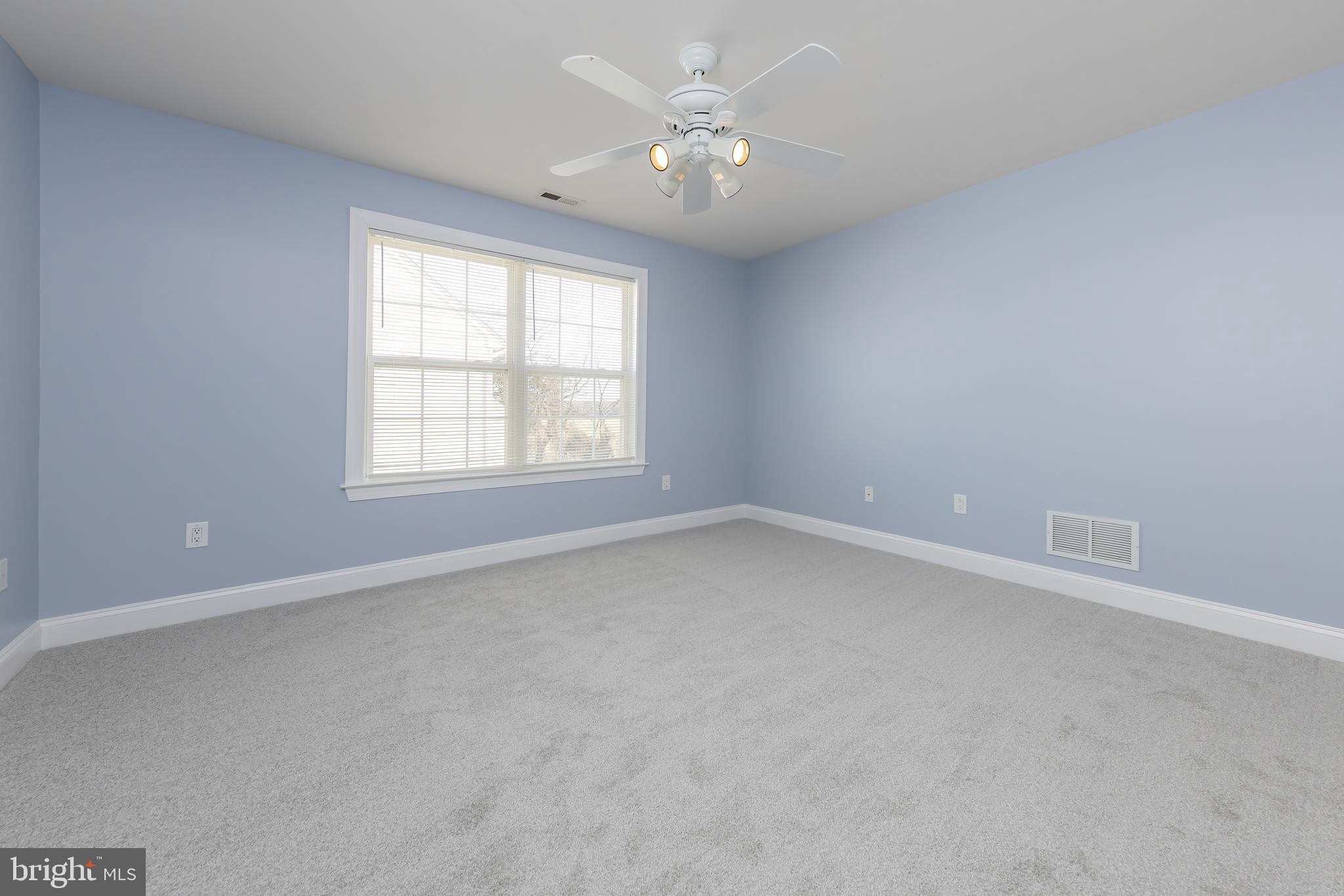 612 Bainbridge Drive Mullica Hill, NJ 08062 - Photo 25 of 42 an empty room with a window and a ceiling fan