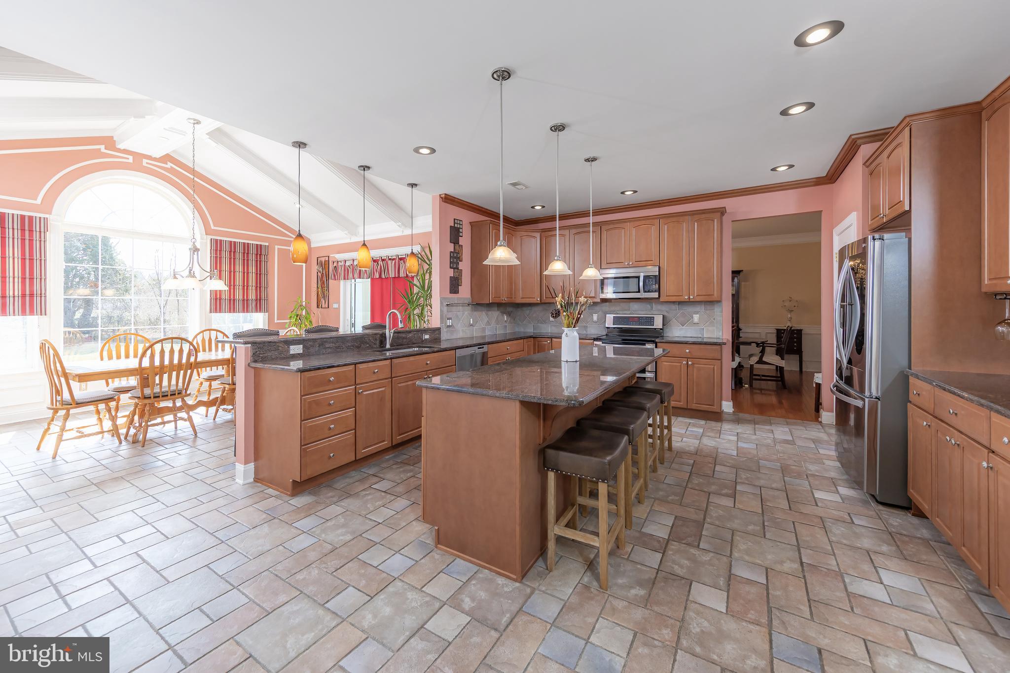 612 Bainbridge Drive Mullica Hill, NJ 08062 - Photo 9 of 42 a kitchen with stainless steel appliances granite countertop a sink cabinets and wooden floor
