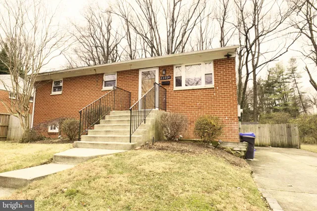 a view of a house with snow on the road