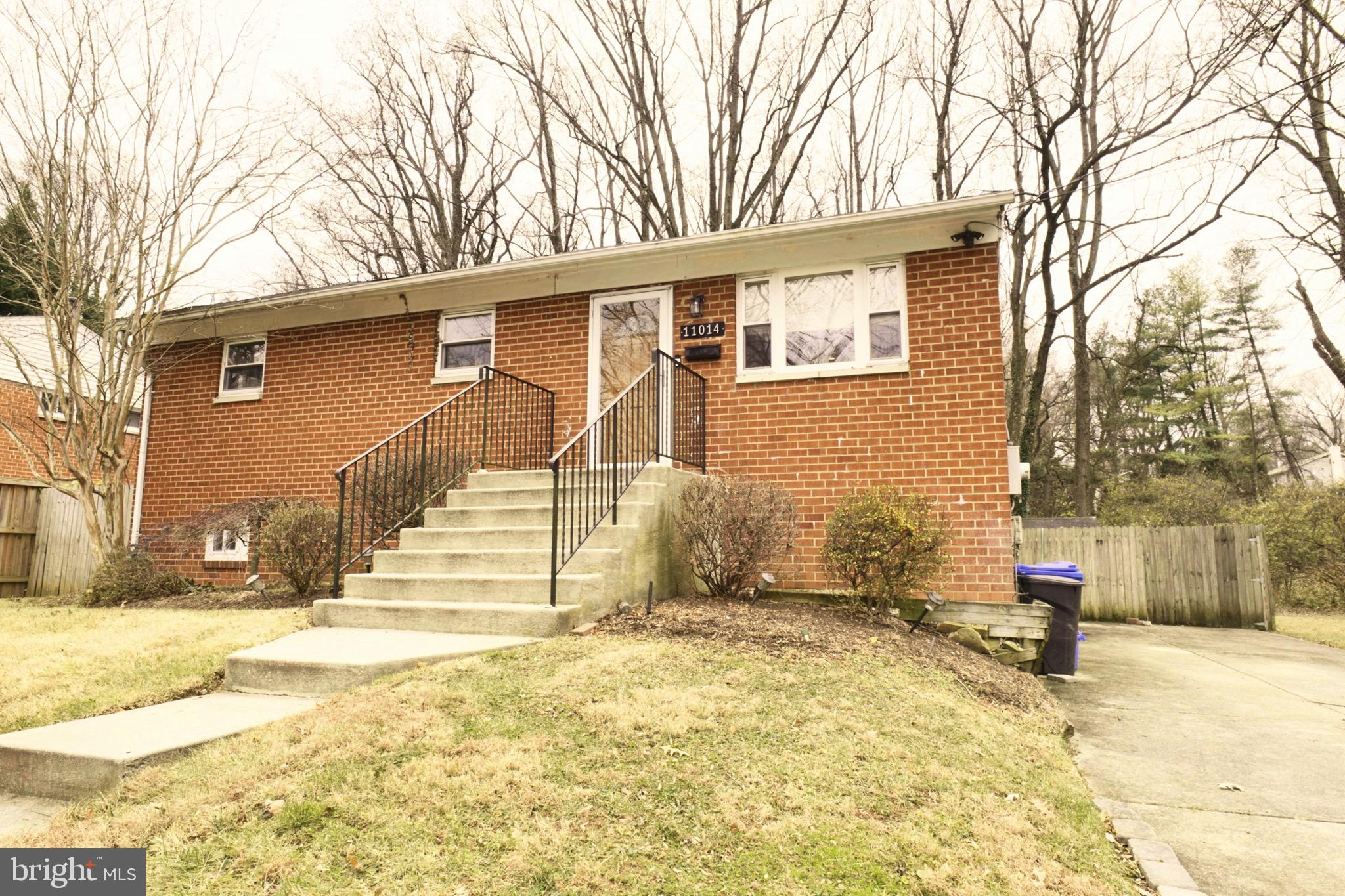 a view of a house with snow on the road