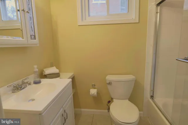 a white toilet sitting next to a bathroom sink