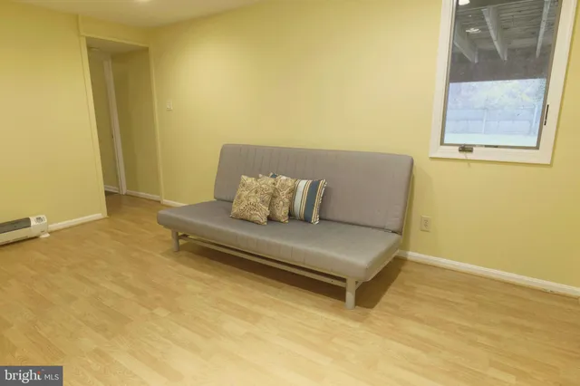 a view of a room with a bathtub and wooden floor